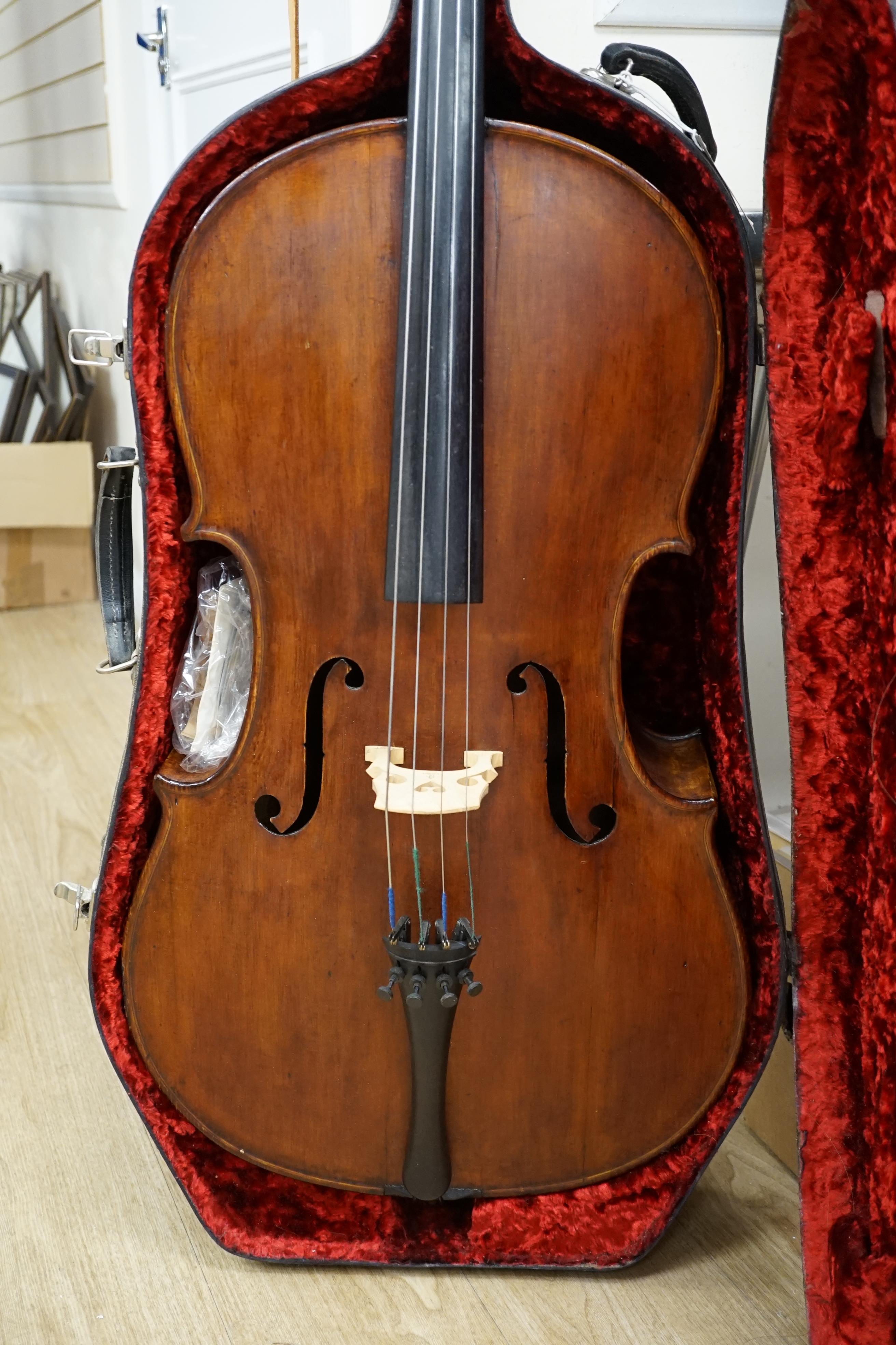 A cased early 20th century ‘cello, length of body 75.5cm, with two spare bridges, and spare strings